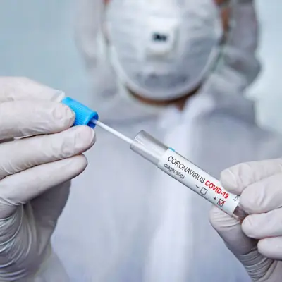 Health care provider preparing a needle for vaccination