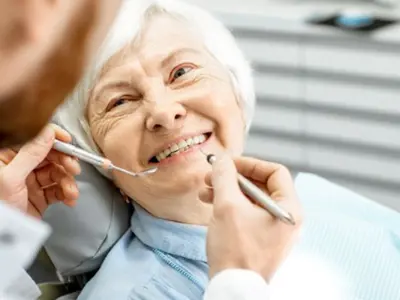 Picture of a senior woman smiling at dentist